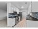 Modern kitchen with white cabinets, stainless steel appliances, and tile flooring at 9868 Appletree Pl, Thornton, CO 80260