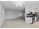 Spacious living room with carpeting and a view into the kitchen at 9868 Appletree Pl, Thornton, CO 80260