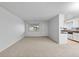 Bright living room with open concept floor plan, featuring a sofa and adjacent dining area at 9868 Appletree Pl, Thornton, CO 80260