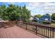 A wooden backyard deck overlooks the fenced yard with trees at 12632 James Ct, Broomfield, CO 80020