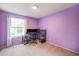 Bedroom in purple with a work station and a sunny window at 12632 James Ct, Broomfield, CO 80020