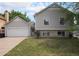 Inviting two-story home featuring a two-car garage and a well-manicured lawn at 12632 James Ct, Broomfield, CO 80020