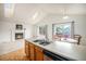 Bright open kitchen with a skylight, fireplace view, and breakfast area at 12632 James Ct, Broomfield, CO 80020