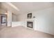 Open-concept living room showcases a fireplace and view to kitchen area at 12632 James Ct, Broomfield, CO 80020
