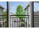 Relaxing balcony view with mature trees and well-kept landscaping at 7140 Simms St # 102, Arvada, CO 80004