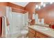 Well-lit bathroom with a tiled shower-tub and ample vanity storage at 7140 Simms St # 102, Arvada, CO 80004