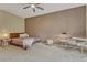 Cozy bedroom features great natural light, carpeted floors, and a neutral color palette at 7140 Simms St # 102, Arvada, CO 80004