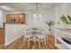 Dining area with modern lighting, a round table, and comfortable seating for four at 7140 Simms St # 102, Arvada, CO 80004
