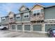 This townhome showcases beautiful stone and siding accents, complemented by attached garages at 7140 Simms St # 102, Arvada, CO 80004