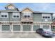 This townhome features well-maintained siding and stone accents, plus convenient garage access at 7140 Simms St # 102, Arvada, CO 80004