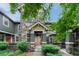 Inviting exterior showcasing the entrance to a townhome with charming stone accents and green siding at 7140 Simms St # 102, Arvada, CO 80004