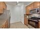 Cozy kitchen with stainless steel appliances, stone countertops, and beautiful wooden cabinets at 7140 Simms St # 102, Arvada, CO 80004