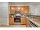 Charming kitchen with stainless steel appliances, stone countertops, and beautiful wooden cabinets at 7140 Simms St # 102, Arvada, CO 80004