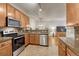 Bright, open kitchen with stainless steel appliances and a view of the living room at 7140 Simms St # 102, Arvada, CO 80004