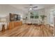 Bright living room with wood floors, large windows, and comfortable seating arrangement at 7140 Simms St # 102, Arvada, CO 80004