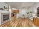 Spacious living area featuring wood floors, an adjacent kitchen, and an inviting dining space at 7140 Simms St # 102, Arvada, CO 80004