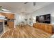 Open-concept living space combining the living room, dining area, and kitchen with sleek wood flooring at 7140 Simms St # 102, Arvada, CO 80004