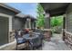 Relaxing patio area features outdoor seating, a grill, and pleasant views of the surrounding landscape at 7140 Simms St # 102, Arvada, CO 80004