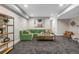 Finished basement featuring a comfortable green sofa, coffee table, and modern decor at 5101 Quitman St, Denver, CO 80212