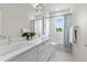 Bright bathroom featuring a double sink vanity with white countertop and modern fixtures, with tub shower at 5101 Quitman St, Denver, CO 80212