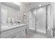 Clean bathroom with a glass-enclosed shower, modern vanity, and white countertops at 5101 Quitman St, Denver, CO 80212