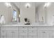 Bright bathroom featuring a double sink vanity with white countertop and modern fixtures at 5101 Quitman St, Denver, CO 80212
