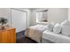 Neutral bedroom with a comfortable bed, sliding closet doors, and natural light at 5101 Quitman St, Denver, CO 80212