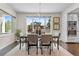 Modern dining room with plenty of natural light from the large windows and stylish decor at 5101 Quitman St, Denver, CO 80212
