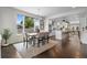 Sun-filled dining room featuring modern lighting, a dining table, and hardwood floors at 5101 Quitman St, Denver, CO 80212