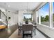 Bright dining room with large windows, modern lighting, and a view of the staircase at 5101 Quitman St, Denver, CO 80212