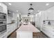 Open kitchen with long island, stainless appliances, and seamless flow to the living area at 5101 Quitman St, Denver, CO 80212