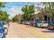 Bustling street featuring shops and parking spots beneath the summer foliage in Denver at 5101 Quitman St, Denver, CO 80212