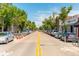 A bustling street view shows many stores with trees lining both sides of the road and cars parked along the sides at 5101 Quitman St, Denver, CO 80212
