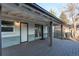 Covered back porch has wooden decking and brick siding, offering outdoor living space at 795 Troy Ct, Aurora, CO 80011