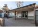 Covered back porch has wooden decking and brick siding with access to the house at 795 Troy Ct, Aurora, CO 80011