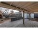 Backyard view showing patio area with wooden railing, shed, and full fence at 795 Troy Ct, Aurora, CO 80011