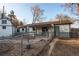 Exterior shot of the home's backyard with shed, patio, and mature trees at 795 Troy Ct, Aurora, CO 80011