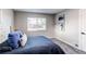 Comfortable bedroom featuring a plush bed, soft carpet, and a bright window at 795 Troy Ct, Aurora, CO 80011