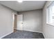 Clean and simple bedroom with soft carpet, a window, and neutral decor at 795 Troy Ct, Aurora, CO 80011