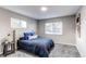 Light-filled bedroom features carpeted floors, updated light fixture, side table and window views at 795 Troy Ct, Aurora, CO 80011