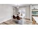 Bright dining room features wood floors, modern lighting, and access to a patio with double doors at 795 Troy Ct, Aurora, CO 80011