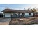 Inviting single-story home with a well-manicured lawn and attached garage at 795 Troy Ct, Aurora, CO 80011