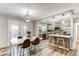 Open-concept kitchen with a dining area, modern lighting, and stainless steel appliances at 795 Troy Ct, Aurora, CO 80011