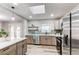This kitchen features a stainless steel refrigerator, quartz countertops, and modern cabinets at 795 Troy Ct, Aurora, CO 80011