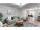 Bright living room featuring modern furnishings and an open floor plan to the dining area at 795 Troy Ct, Aurora, CO 80011