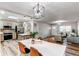 Spacious living space with modern lighting, wood floors, an open floorplan and an eat-in kitchen at 795 Troy Ct, Aurora, CO 80011