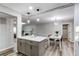 Open-concept living space with sightlines to kitchen, dining room and living room with modern pendant lighting at 795 Troy Ct, Aurora, CO 80011