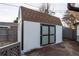 Exterior of the backyard shed, featuring a brown roof and paneled doors at 795 Troy Ct, Aurora, CO 80011
