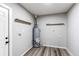 Utility room with neutral decor, wood look flooring and shelving at 795 Troy Ct, Aurora, CO 80011