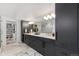 Elegant bathroom with double vanity, marble floors, and a glass-enclosed shower, showcasing luxurious design at 3709 Tejon St, Denver, CO 80211